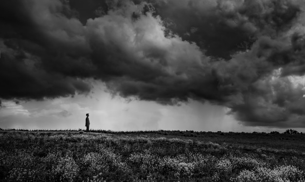 Figure watching storm