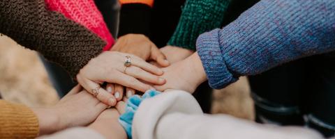 Group placing hands on top of each other